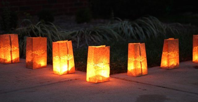 paper bag luminaries lined up along a sidewalk